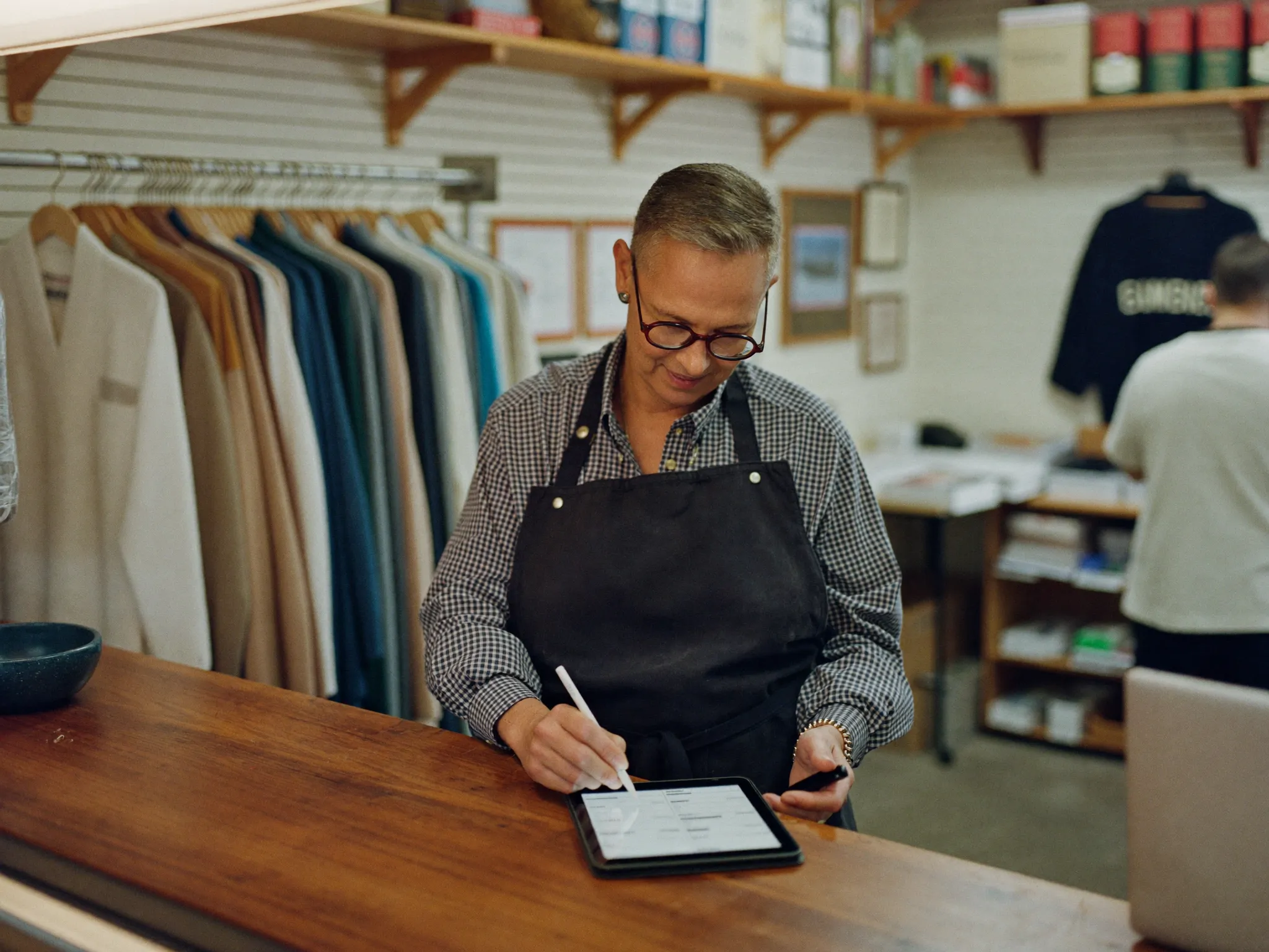 Small-business owner working at the counter of a main-street shop