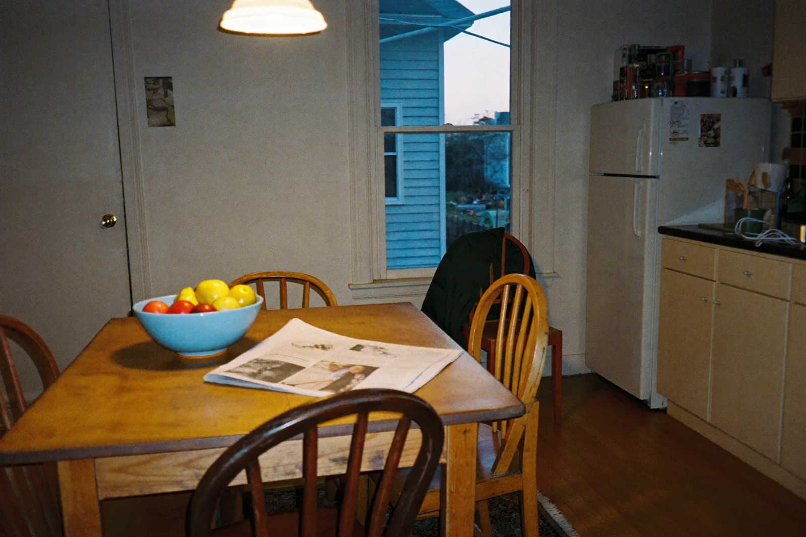 The kitchen table of a lived-in family home in the evening